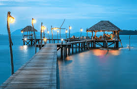 Waterfront dining pier lit up in the evening